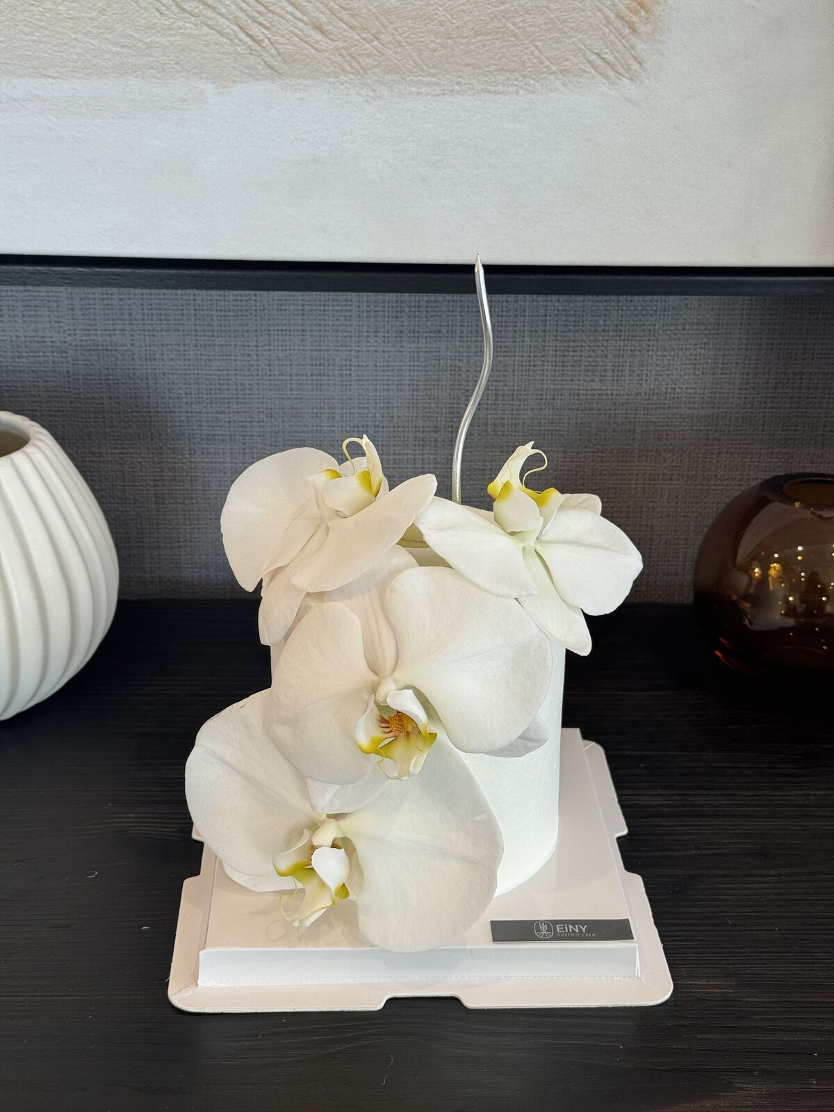 White orchid cake photographed in the studio